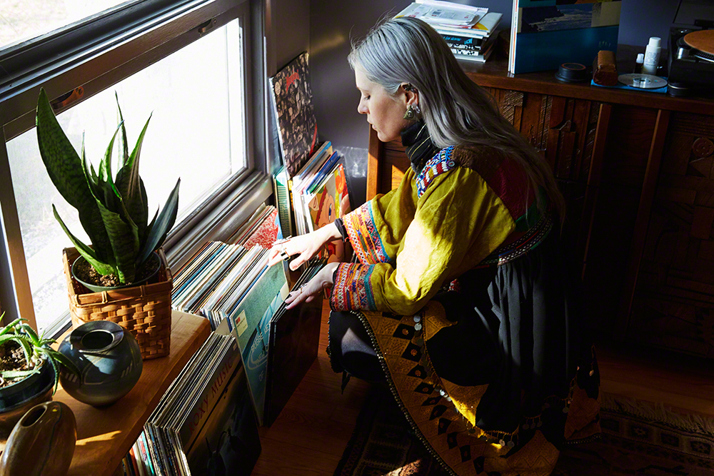 Sarah Ellison in Woodstock flipping through vinyl records.