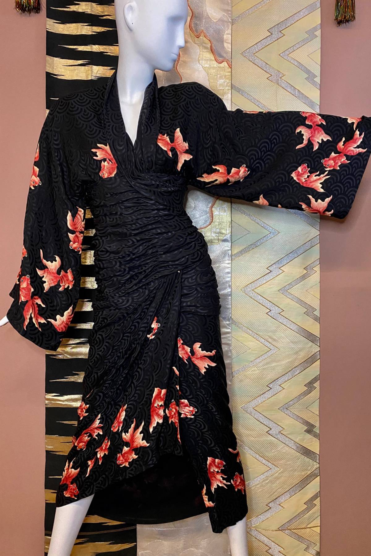 Vintage dress on mannequin in front of silk backdrop